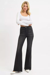 Model wearing RISEN high rise flare raw cut hem jeans plus size — casual vintage look